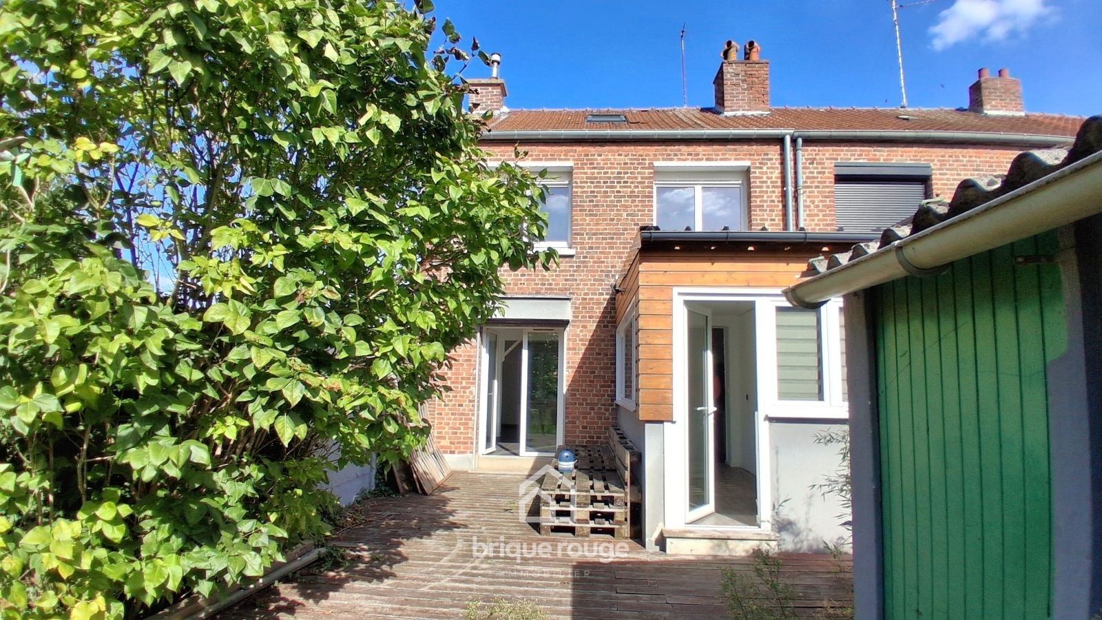 Maison semi individuelle 3 chambres et jardin Photo 1 - Brique Rouge Immobilier
